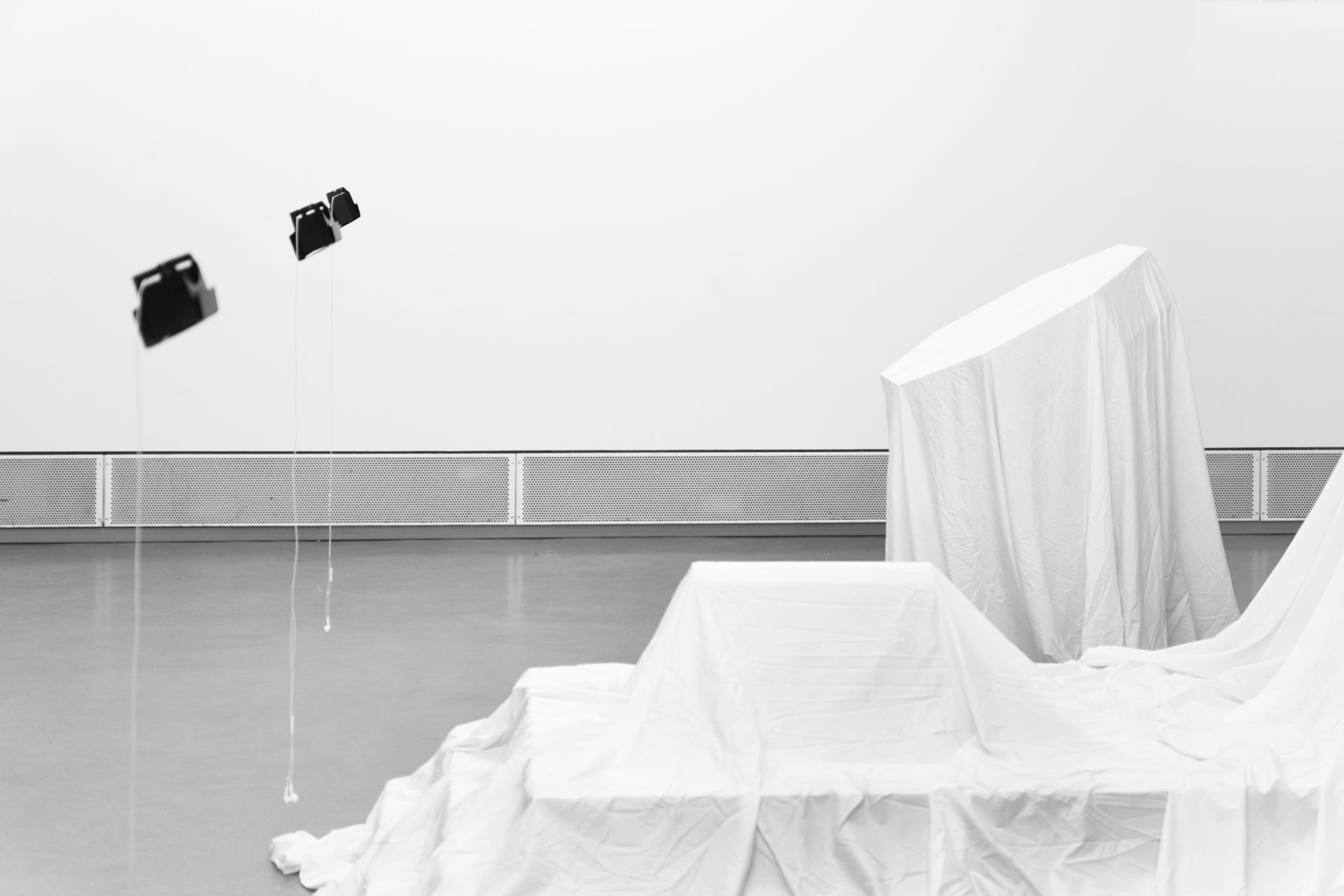 Interzone: Side view of veiled life-sized sculptures exploring human rituals and sacred aesthetics